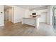 Open-concept kitchen boasts white cabinets, stainless appliances, and a granite island with backyard access at 4167 Viola Pl, Atlanta, GA 30349