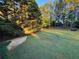 Large, well-maintained backyard featuring lush green grass and mature trees for shade and privacy at 5382 Whitaker Nw Trl, Acworth, GA 30101