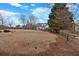 Large backyard of white home with black roof, complete with wooded perimeter and fence at 5382 Whitaker Nw Trl, Acworth, GA 30101