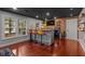 Basement bar with stools, exposed brick, and mini fridge at 5382 Whitaker Nw Trl, Acworth, GA 30101