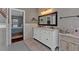 Modern bathroom with double vanities, decorative rug, and view into the spacious main bedroom at 5382 Whitaker Nw Trl, Acworth, GA 30101
