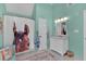Bright bathroom with large window, horse themed shower curtain, and blue accents at 5382 Whitaker Nw Trl, Acworth, GA 30101