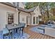 Outdoor deck featuring seating areas, a table and chairs with a blue area rug next to the home's exterior at 5382 Whitaker Nw Trl, Acworth, GA 30101