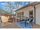 Outdoor deck featuring a table and chairs with a blue area rug next to the home's exterior at 5382 Whitaker Nw Trl, Acworth, GA 30101