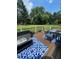 Outdoor deck featuring a dark sofa, table and chairs with a blue area rug overlooking the backyard at 5382 Whitaker Nw Trl, Acworth, GA 30101
