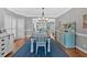 Bright dining area featuring a blue area rug, ample natural light, and access to the kitchen area at 5382 Whitaker Nw Trl, Acworth, GA 30101