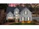 Charming home with elegant gray shutters, manicured lawn, and brick steps leading to an arched entryway at 5382 Whitaker Nw Trl, Acworth, GA 30101