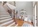 Sunlit foyer featuring hardwood floors, staircase, and decor accents that create a warm, welcoming atmosphere at 5382 Whitaker Nw Trl, Acworth, GA 30101