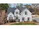 Charming two-story home with elegant white exterior, manicured landscaping, and a basketball hoop in background at 5382 Whitaker Nw Trl, Acworth, GA 30101