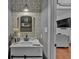 Charming half bathroom with decorative tile, mirror, and stylish vanity sink at 5382 Whitaker Nw Trl, Acworth, GA 30101