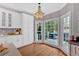 Stylish kitchen with a view of the outdoor deck, white cabinets, and pendant lighting at 5382 Whitaker Nw Trl, Acworth, GA 30101