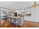 Well-lit kitchen with white cabinets, island seating, and modern pendant lighting at 5382 Whitaker Nw Trl, Acworth, GA 30101