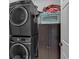 Efficient laundry area features stacked washer and dryer, plus extra storage at 5382 Whitaker Nw Trl, Acworth, GA 30101