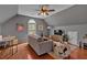 Cozy living area featuring hardwood floors, sofa, bean bag chair, and arched window at 5382 Whitaker Nw Trl, Acworth, GA 30101