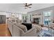 Open-concept living room and kitchen with a cozy fireplace, stainless steel appliances, and bright white cabinetry at 5382 Whitaker Nw Trl, Acworth, GA 30101