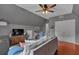 Cozy living room with hardwood floors, comfortable seating, and a ceiling fan at 5382 Whitaker Nw Trl, Acworth, GA 30101