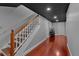 Basement staircase with hardwood stairs and a dark ceiling at 5382 Whitaker Nw Trl, Acworth, GA 30101