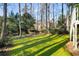 Spacious backyard with a swing set and lush green grass and mature landscaping at 2212 Austin Lake Se Dr, Smyrna, GA 30082