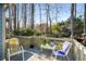 Outdoor deck with seating and peaceful views of the wooded backyard at 2212 Austin Lake Se Dr, Smyrna, GA 30082