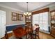 Formal dining room with hardwood floors, large window, and a china cabinet, and wainscoting at 2212 Austin Lake Se Dr, Smyrna, GA 30082