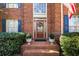 Inviting front entrance featuring brick steps, potted plants, and a wreath on the wood door at 2212 Austin Lake Se Dr, Smyrna, GA 30082