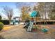 Community playground featuring a slide, climbing wall, swings, and tire swing near a tennis court at 2212 Austin Lake Se Dr, Smyrna, GA 30082