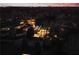 Night aerial view showcasing a modern home with illuminated windows and surrounding landscape at 238 Olympic Pl, Decatur, GA 30030