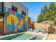 A backyard featuring a pool, lounge area, artistic mural, and lush greenery at 238 Olympic Pl, Decatur, GA 30030