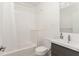 Bright bathroom with a shower-tub combination, tile walls, and vanity sink at 238 Olympic Pl, Decatur, GA 30030