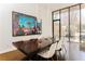 Contemporary dining room with dark wood table, comfortable chairs, and modern art, with a large window for natural light at 238 Olympic Pl, Decatur, GA 30030