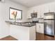 Efficient kitchen with stainless steel appliances, white cabinetry, and breakfast bar at 238 Olympic Pl, Decatur, GA 30030