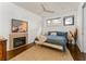 Serene main bedroom with a fireplace, ceiling fan, and ample natural light at 238 Olympic Pl, Decatur, GA 30030