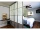 Bright bedroom with frosted sliding doors, a bed, and minimalist decor at 2886 Salmon Se Ave, Atlanta, GA 30317