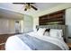 Bright bedroom featuring a ceiling fan, sliding doors, and a stylish bookshelf headboard at 2886 Salmon Se Ave, Atlanta, GA 30317