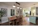 Dining area flowing into a kitchen with pale green cabinets and a granite countertop island at 2886 Salmon Se Ave, Atlanta, GA 30317