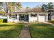 Inviting single-story home with a blue front door and a well-manicured green lawn at 2886 Salmon Se Ave, Atlanta, GA 30317