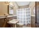 Neutral bathroom featuring a pedestal sink, toilet and shower with striped curtain at 698 Bellemeade Nw Ave, Atlanta, GA 30318