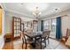 Elegant dining room with large windows, a classic chandelier, and ample seating at 698 Bellemeade Nw Ave, Atlanta, GA 30318