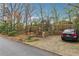 Driveway leading up to a brick house with an adjacent parking space and car at 698 Bellemeade Nw Ave, Atlanta, GA 30318