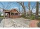 Charming brick home with a covered carport, an adjacent parking pad, and mature trees at 698 Bellemeade Nw Ave, Atlanta, GA 30318