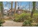 Charming brick home featuring beautiful landscaping and a stone walkway, nestled amongst mature trees at 698 Bellemeade Nw Ave, Atlanta, GA 30318