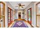 Charming hallway with red doors, wood shutters, hardwood floors and colorful rug at 698 Bellemeade Nw Ave, Atlanta, GA 30318