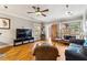 Comfortable living room featuring a large TV, hardwood floors, and a cozy seating area at 698 Bellemeade Nw Ave, Atlanta, GA 30318