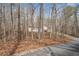 Charming home surrounded by trees, featuring a red deck, and private driveway at 95 Riverbrooke Trl, Covington, GA 30016