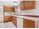 Kitchen sink and dishwasher next to the white countertops and wooden cabinets at 95 Riverbrooke Trl, Covington, GA 30016