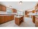 Kitchen featuring wood cabinets, central island, and modern appliances at 95 Riverbrooke Trl, Covington, GA 30016