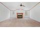 Large living room with neutral carpet, ceiling fan and traditional fireplace at 95 Riverbrooke Trl, Covington, GA 30016