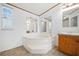 Bright bathroom with a soaking tub and large vanity, offering a peaceful retreat at 95 Riverbrooke Trl, Covington, GA 30016