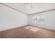 Large bedroom with neutral carpet, ceiling fan, and natural light from a large window at 95 Riverbrooke Trl, Covington, GA 30016