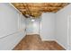 Spacious unfinished basement with exposed ceiling, tiled floor, and access door at 97 Spring Leaf Dr, Dallas, GA 30157